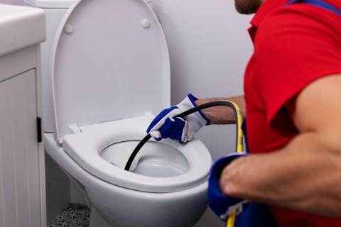 Loodgieter maakt toilet verstopping los met hydro-jet technique.