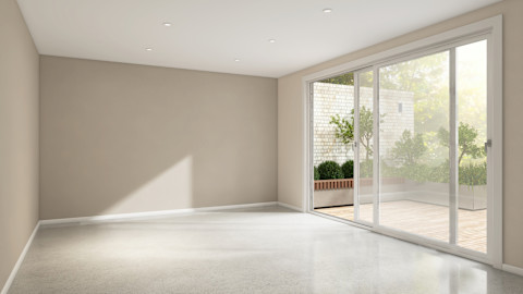Lege kamer met beige-bruine muur en zonlicht dat door het raam naar binnen valt, waardoor warme schaduwen op de vloer ontstaan.