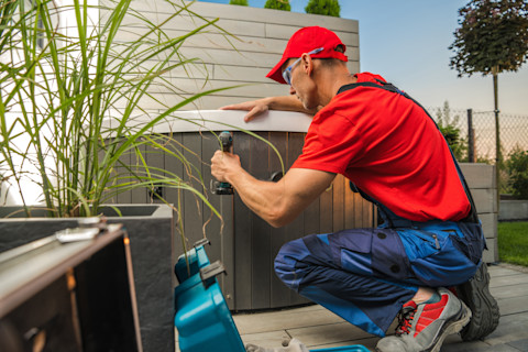 Technicus rondt de installatie van een dompelbad in de tuin af, met aandacht voor afwerking en aansluitingen.