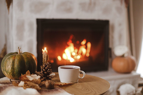 Een haard met een vuur in een warme herfstachtige woning