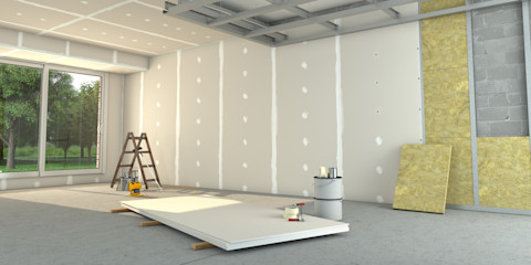 Een muur wordt met witte isolatieplaten geisoleerd in een grote ruime lege ruimte.