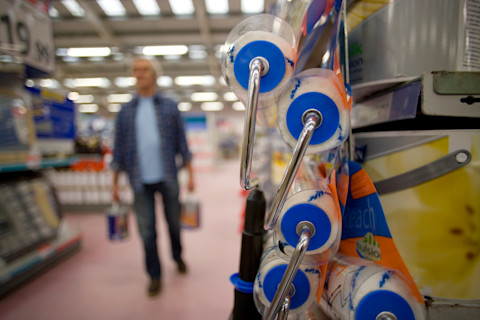 Verfrollers in de voorgrond, schildermateriaal op een rij